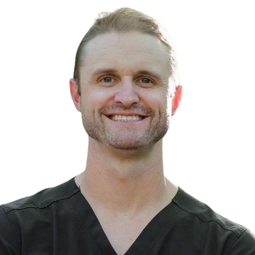 Smiling man in dark scrubs, isolated on a white background.